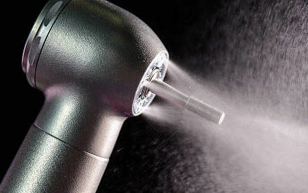 dental hand-piece with diamond cylinder bur and water spray.